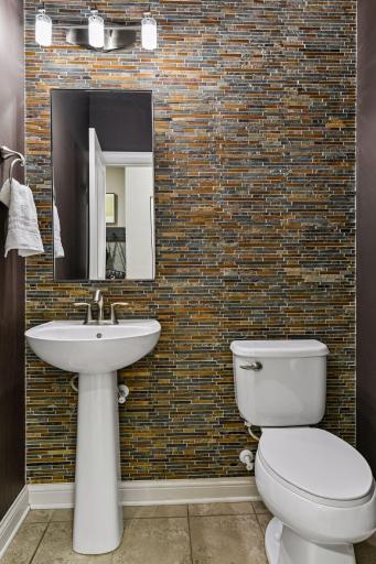 Half bath on the main floor with stone backsplash accent wall