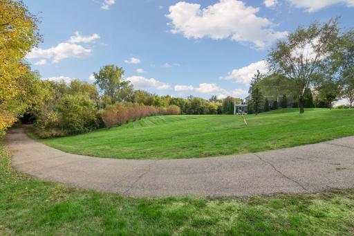 View of flat backyard that extends to path