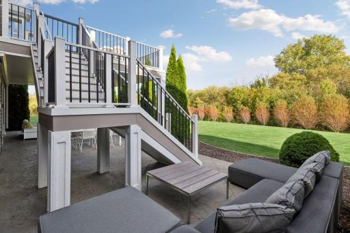 Outdoor lounge seating from the patio at the bottom of the deck stairs