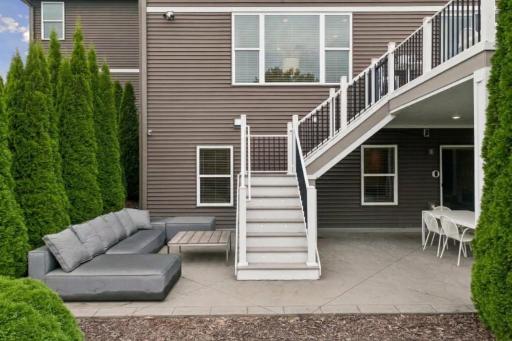 Deck staircase landing to patio with outdoor seating