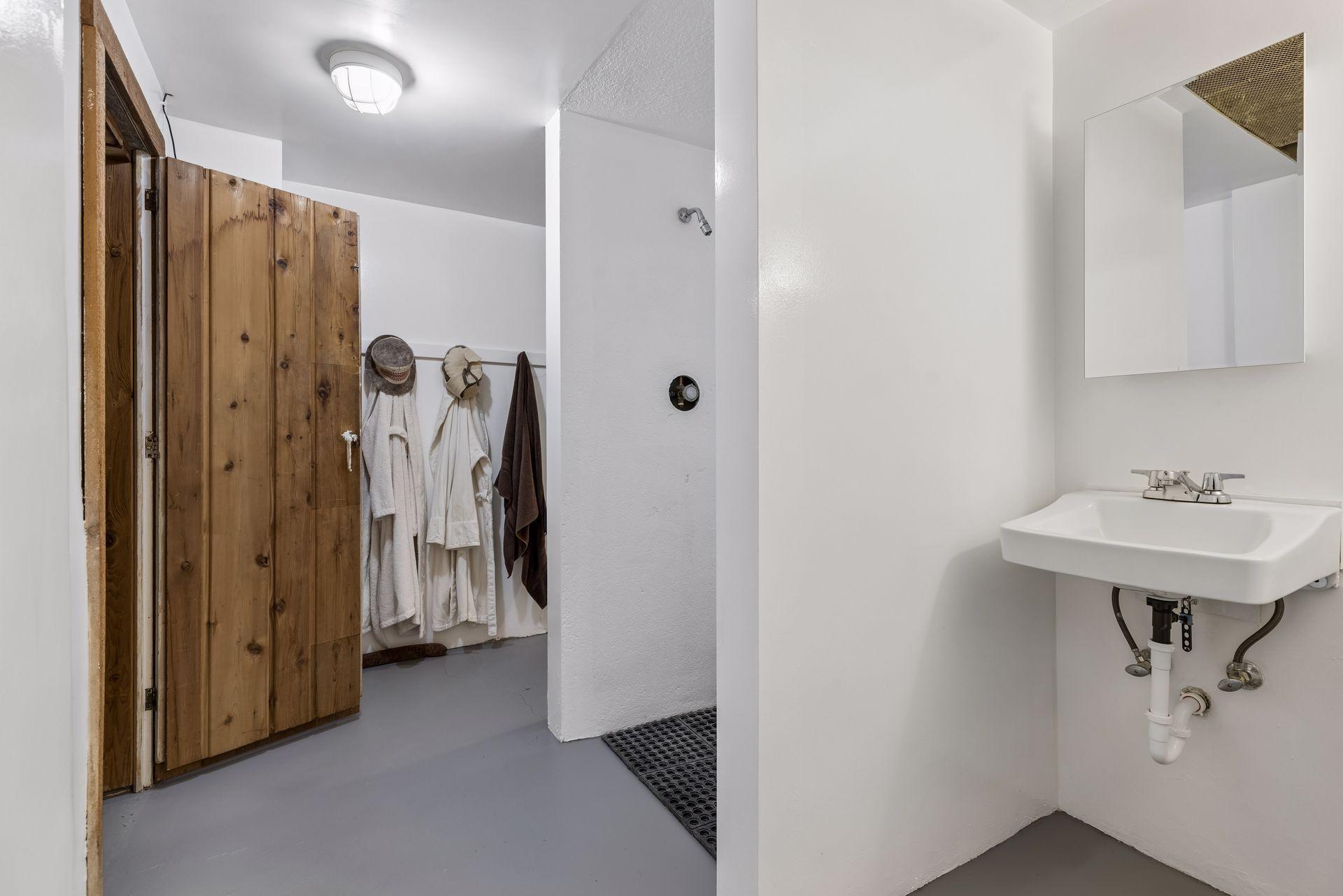 Three-quarter bathroom adjacent to the sauna, offering added functionality (not included in the home's bathroom count).