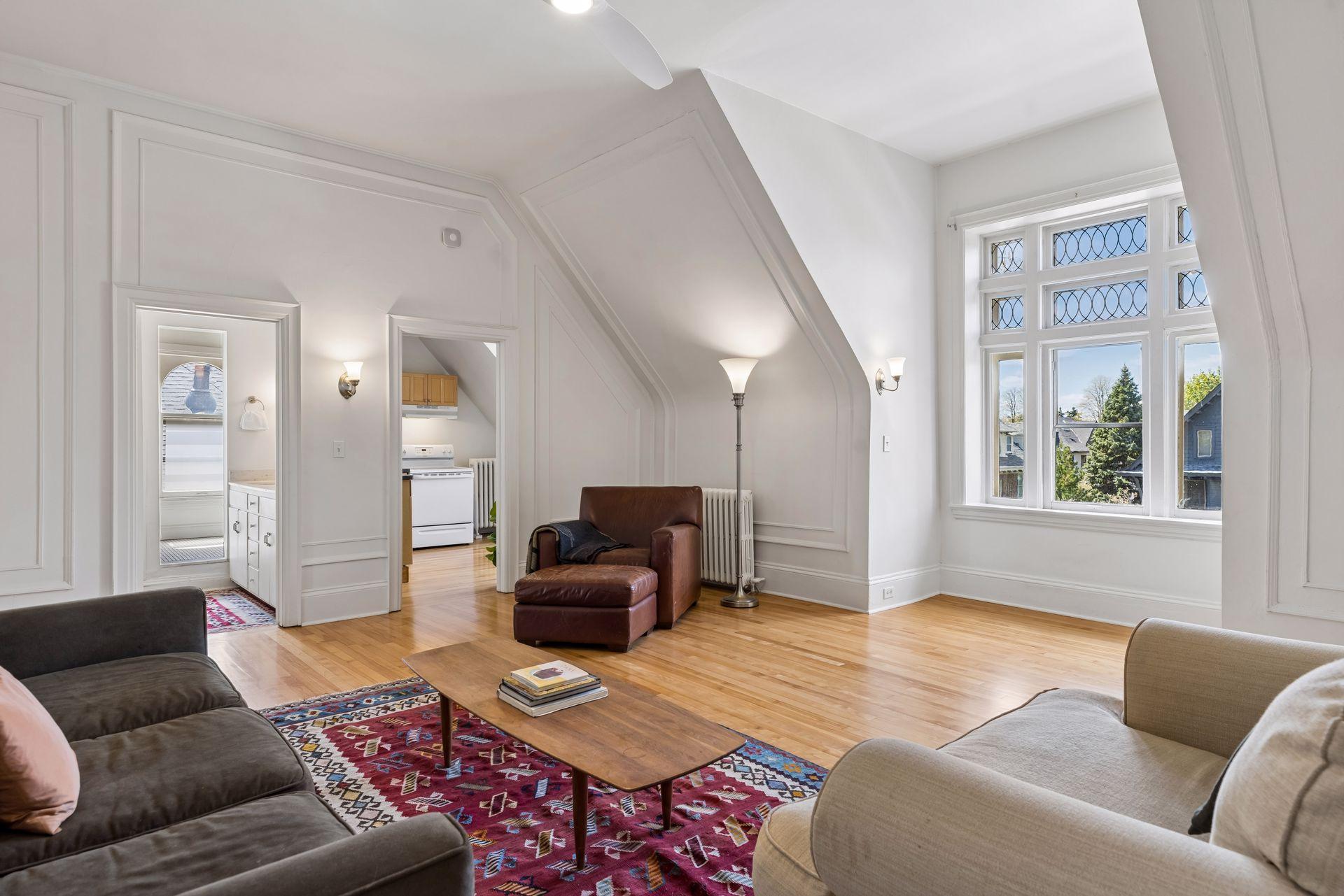 Bright third-level living room with an open, airy feel—creating a comfortable central space that ties the level together.
