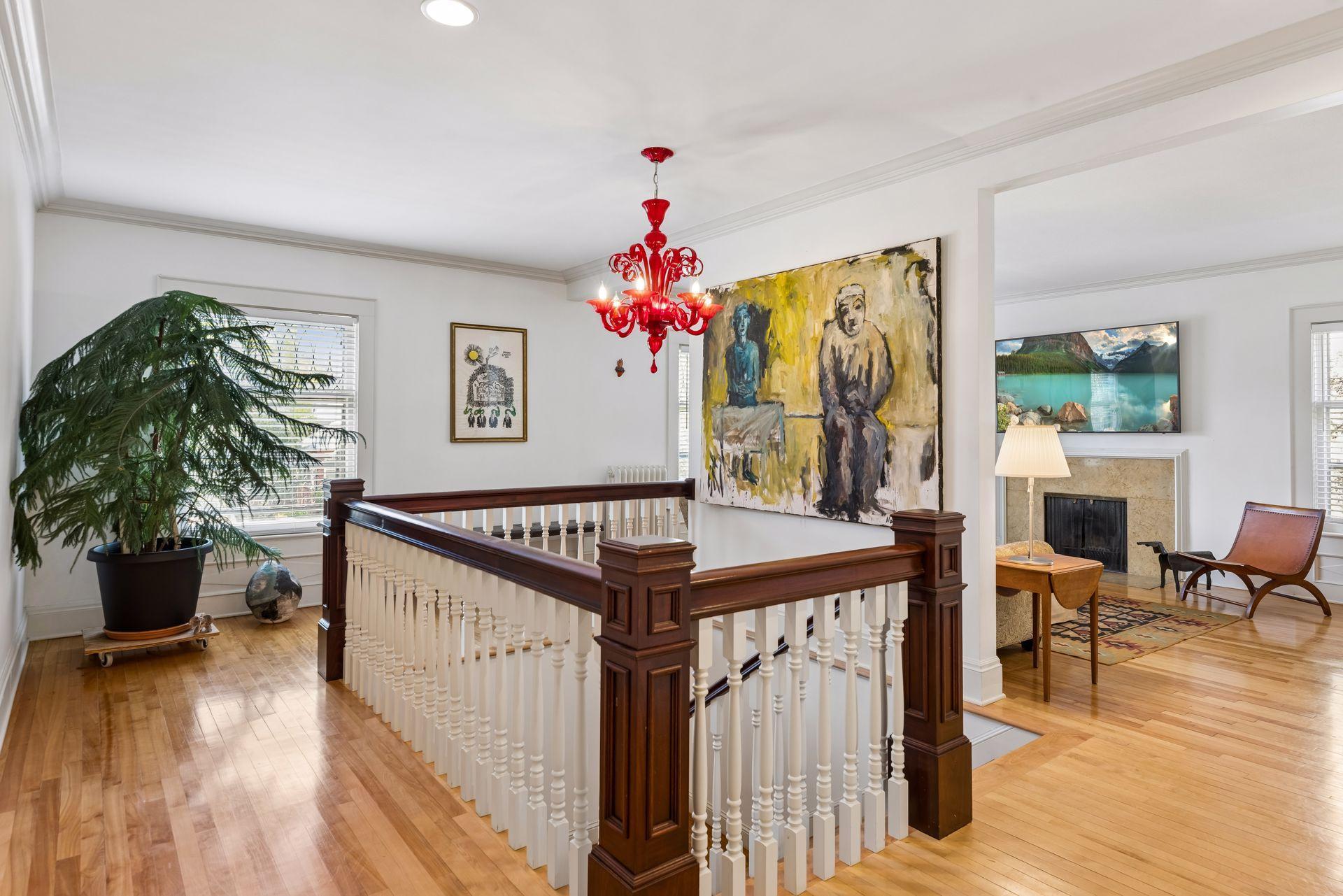 The second floor offers a bright secondary living space with a stone fireplace, filled with warm natural light and a peaceful tree-top feel.