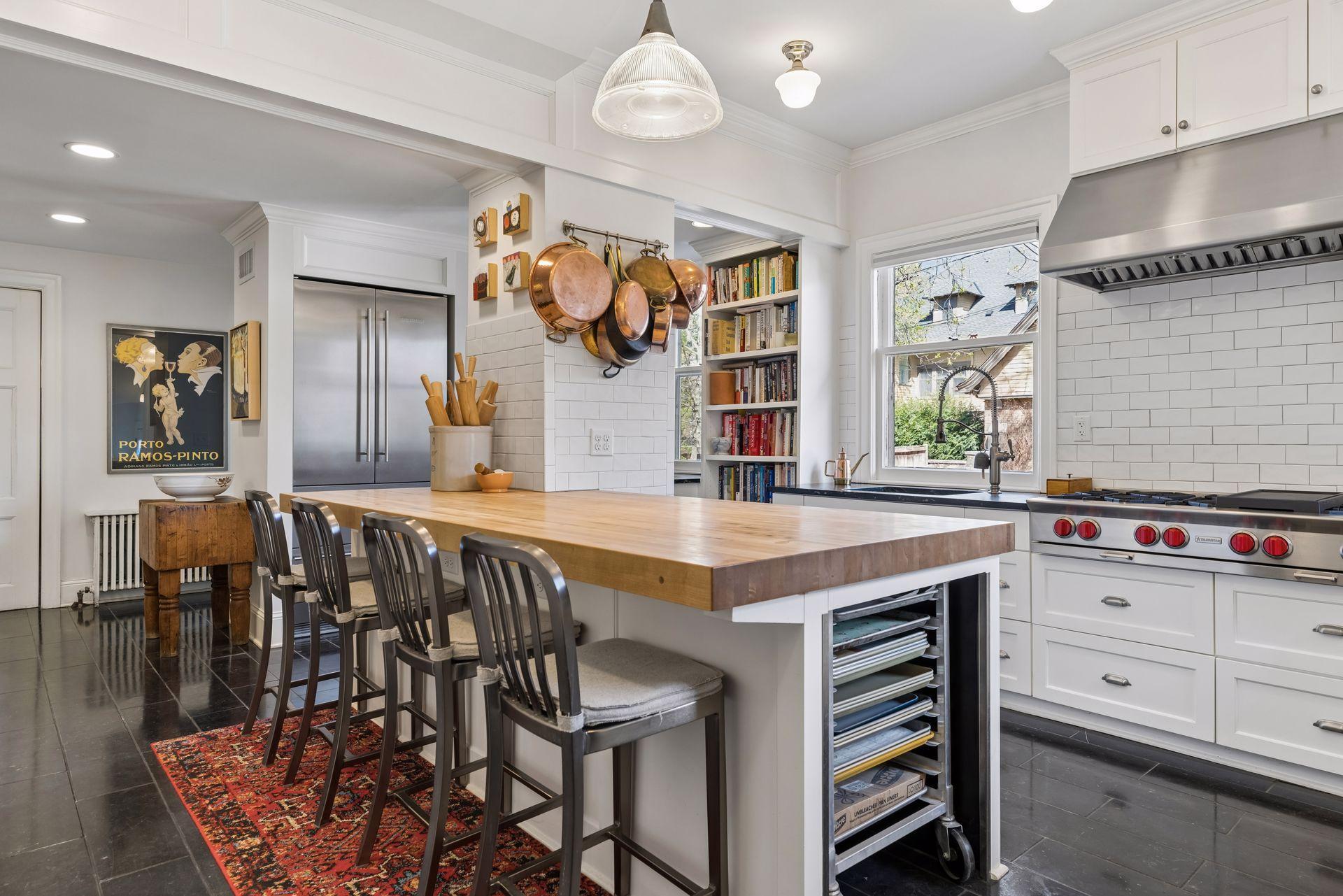 Complete with custom designed Blue-Star double wall ovens with pizza stone, two Bosch dishwashers, two high-end refrigerators (Liebherr and Subzero brands), marble countertops and butcher block center island, and Blue-Star gas range with Prizer Hood.