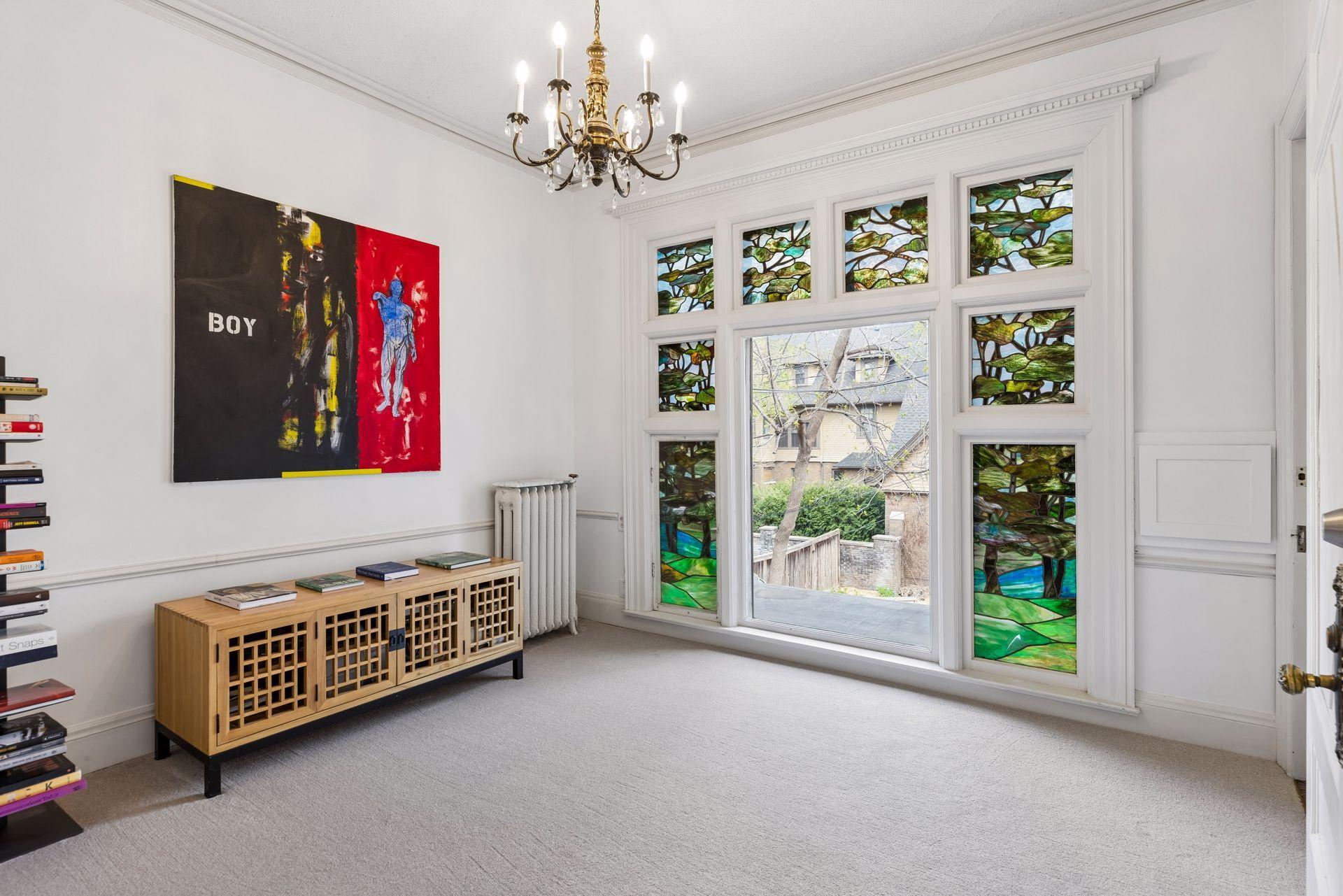 Light-filled second-level office with beautiful stained glass windows overlooking the backyard. Offers access to the third level, allowing for a private entry or seamless integration with the rest of the home.