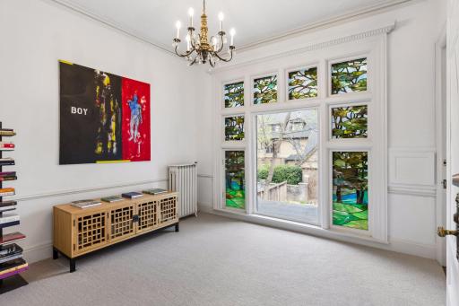 Light-filled second-level office with beautiful stained glass windows overlooking the backyard. Offers access to the third level, allowing for a private entry or seamless integration with the rest of the home.
