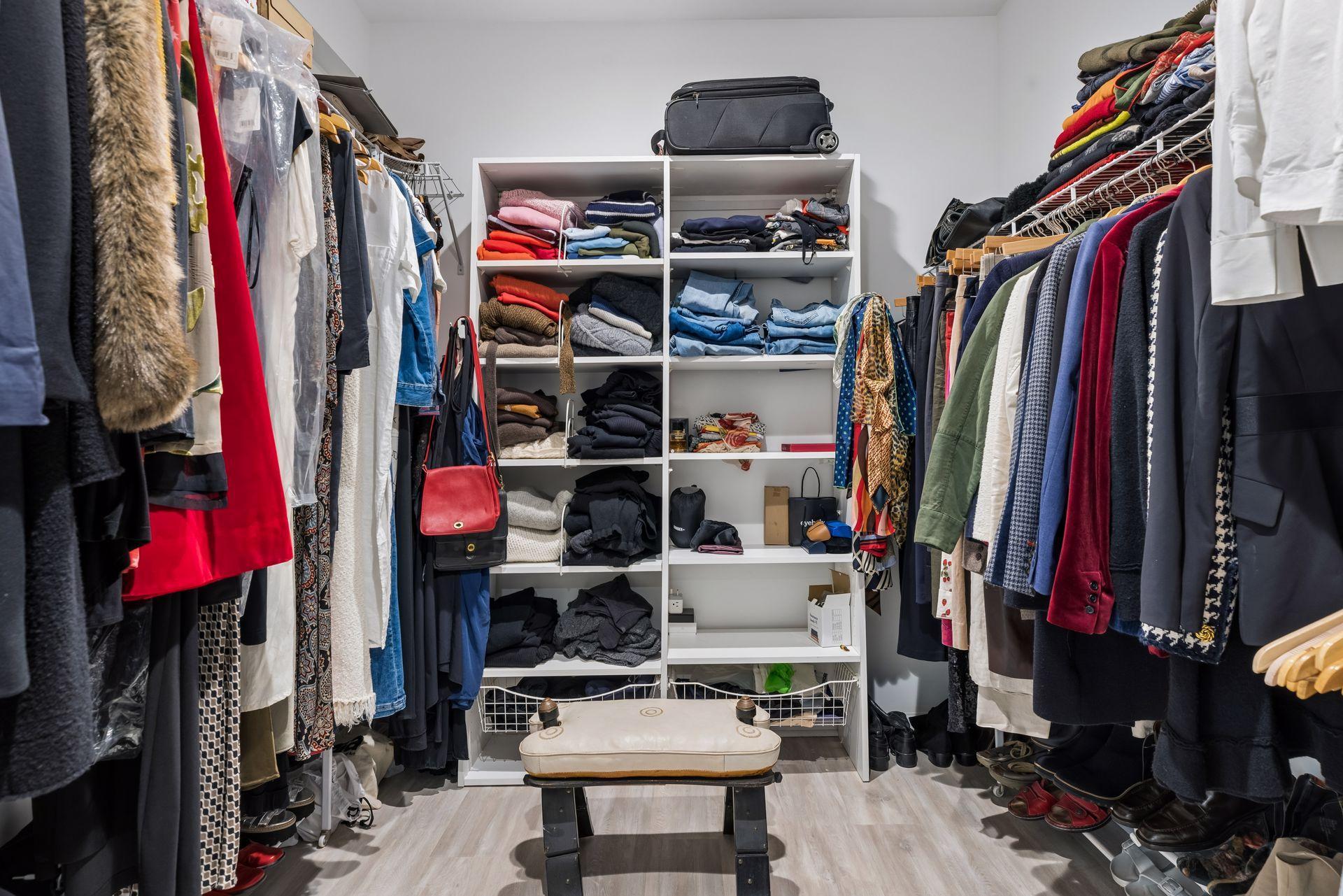 Dedicated second-level dressing room featuring built-in storage, ample hanging space, and an organized, functional layout.