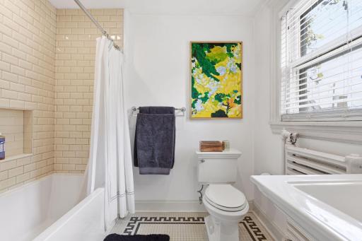 Primary ensuite bathroom, with original tile floor.