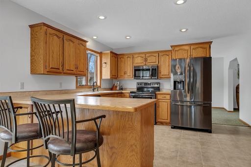 Open Kitchen with Newer Black Stainless Steel Appliances
