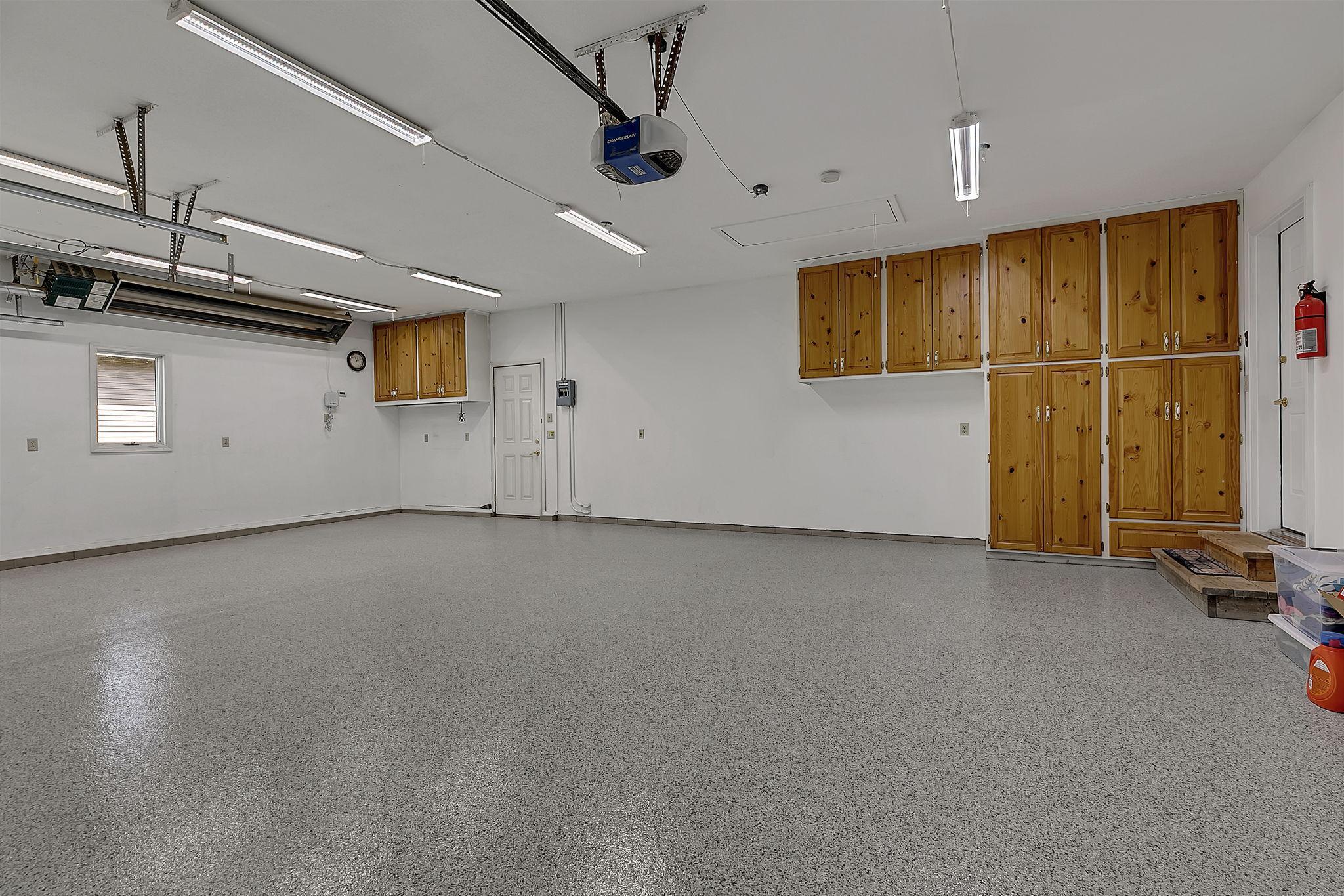 Finished 3 Stall Garage with Built -n Cabinets - Access Door Leads to Back Yard - Heater Stays