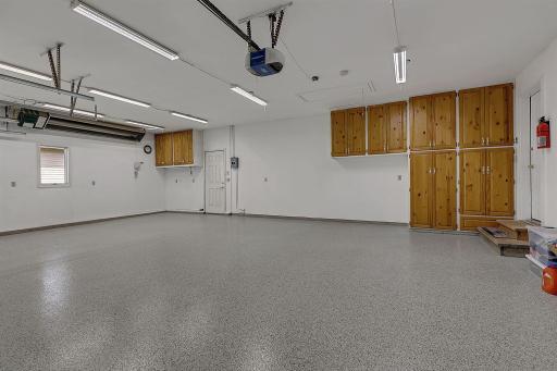 Finished 3 Stall Garage with Built -n Cabinets - Access Door Leads to Back Yard - Heater Stays
