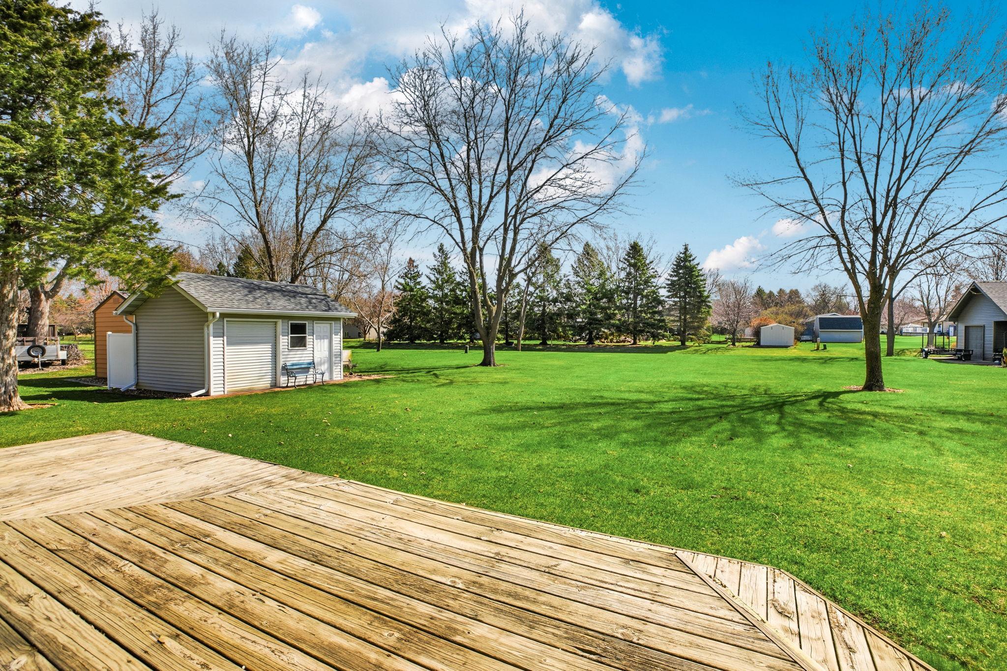 Deck and Patio Overlooks the Backyard - Easy Access from Great Room - Mature Trees add Privacy