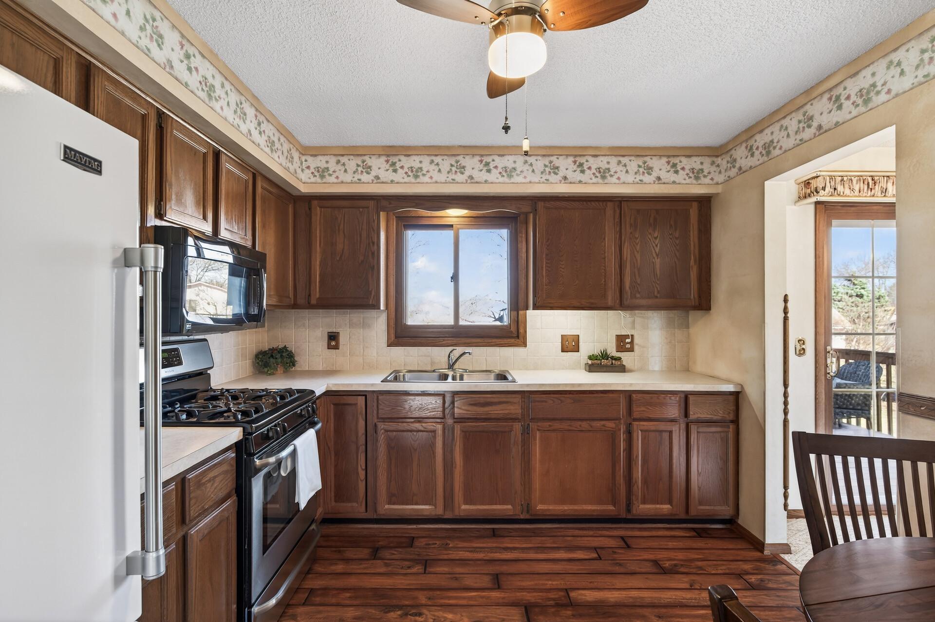 The kitchen window fills the kitchen with natural light and offers a great view to the backyard to keep watch of kids and furry friends.