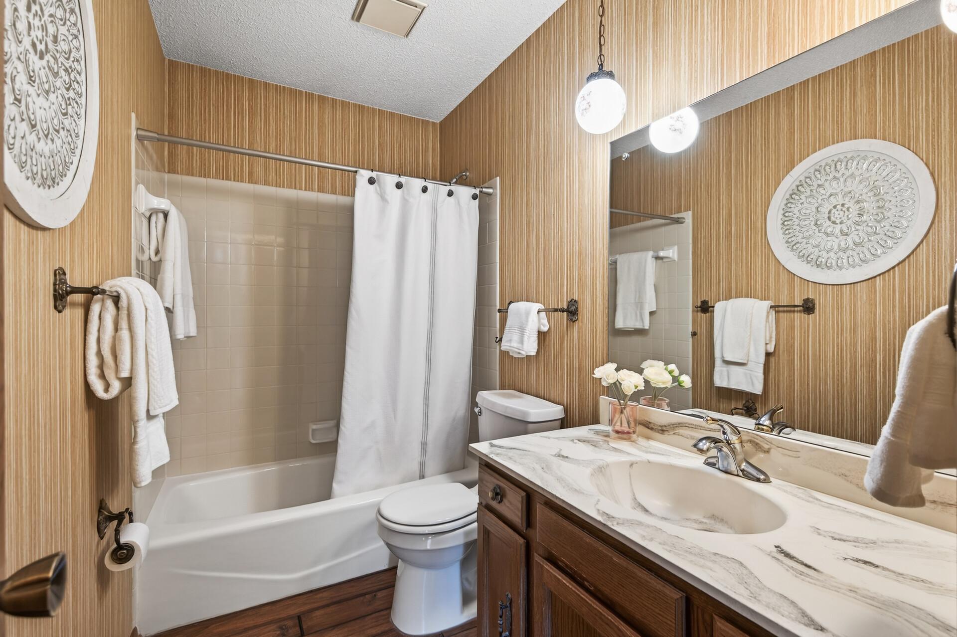 Primary bathroom on upper level with vintage charm.