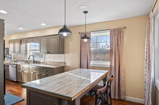 Enjoy this butcher block topped island for added storage, counter space and seating