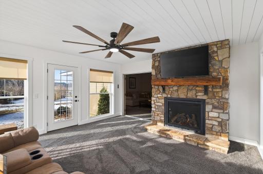 A stone surround gas fireplace completed the beautiful sun room