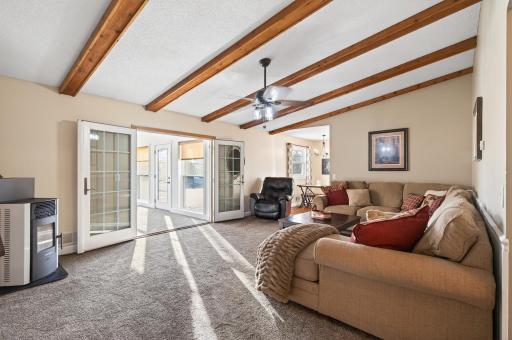 Fantastic living room with wood beam detail and a pellet stove