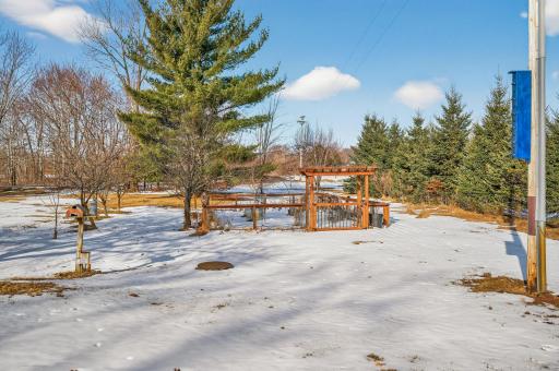 Large, fenced garden area with fruit trees/shrubs nearby