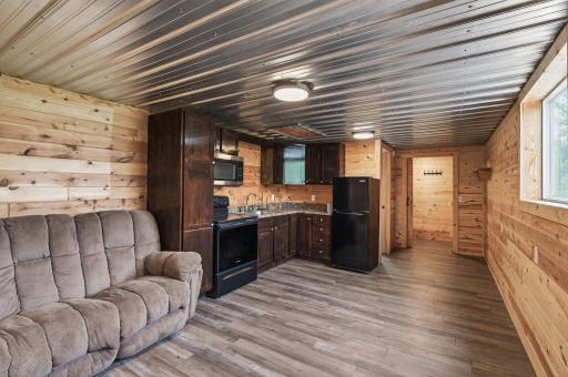 The loft space features a flex room, living room, full kitchen and 1/2 bathroom. Use as a hang out space or as an office set up.