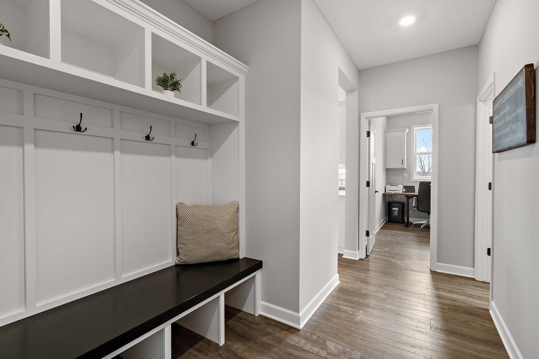 From the garage you step into a practical & inviting space featuring a built-in bench with storage for shoes, backpacks, and daily essentials. This thoughtful design keeps the home organized while offering a convenient drop zone for busy days.