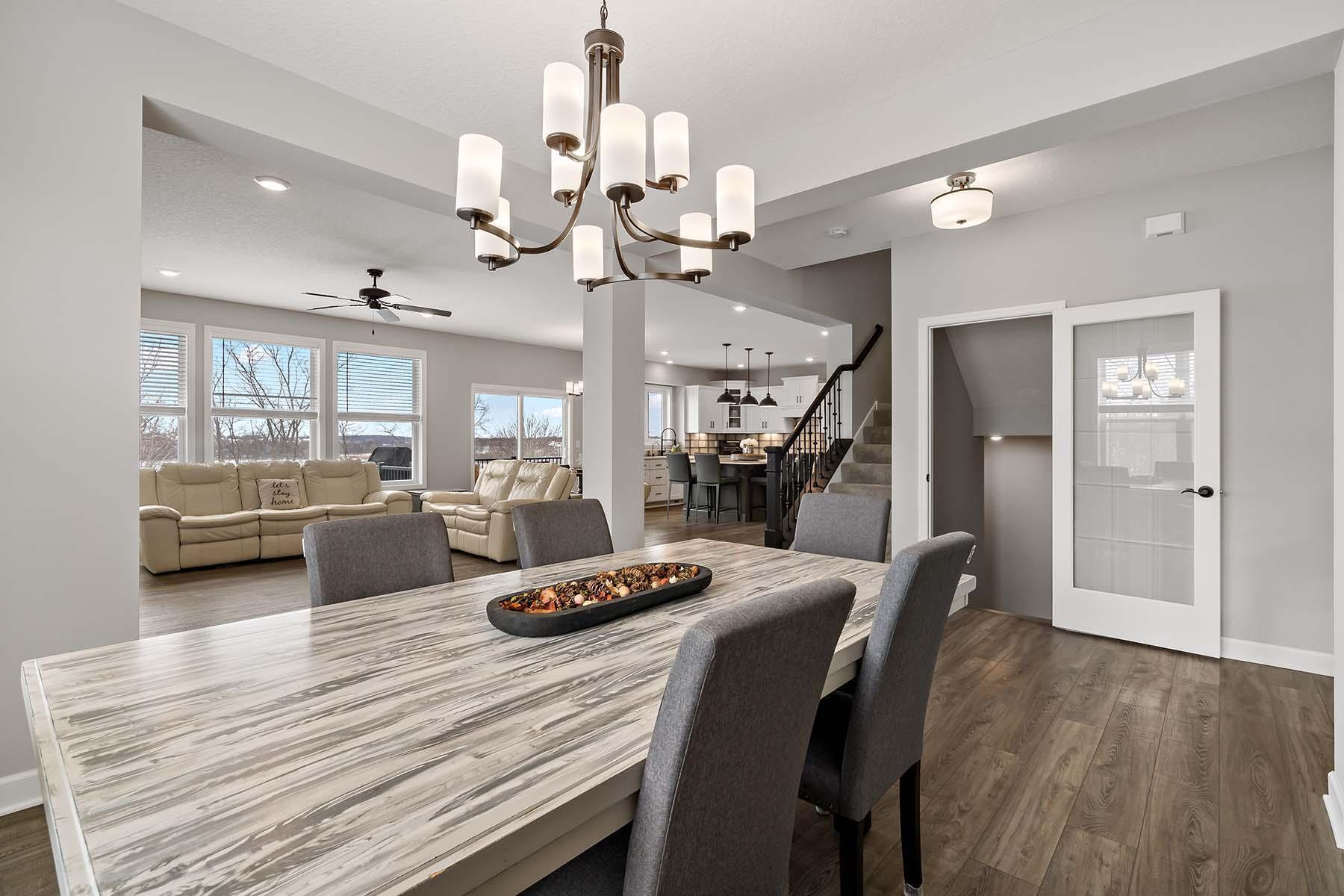 The dining area is perfectly positioned to overlook both the kitchen & living room, creating a seamless flow ideal for everyday living & entertaining. An elegant chandelier adds modern sophistication to the space.