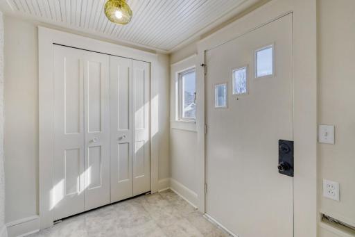 Front porch is large, heated, and has large sized coat closed.