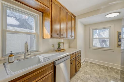 Windows on two sides of the galley kitchen fill the space with natural light.