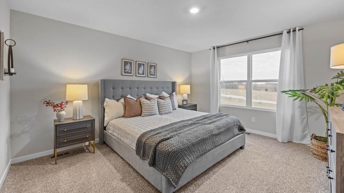 Large primary bedroom. King size bed. Photos are of similar staged home. Colors and options may vary. Ask Sales Agent for details.
