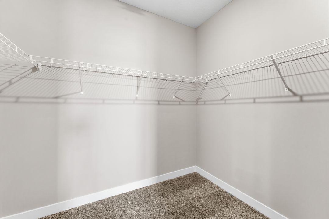 Harmony Primary Walk-in Closet. Photos are of similar staged home. Colors and options may vary. Ask Sales Agent for details.