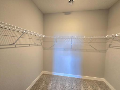 Harmony Primary Bedroom Walk-in Closet. Photos are of actual home. Colors and options may vary. Ask Sales Agent for details.