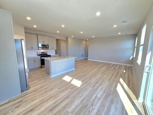 Harmony Kitchen open onto Living and Dining Rooms. Photos are of actual home. Colors and options may vary. Ask Sales Agent for details.