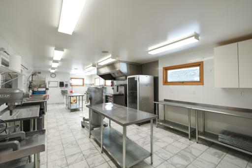 Again, new tile, updated windows and a large space. The end closest to you in the picture; all the stainless steel tables are removable if interested and create a larger open space to suit your needs.