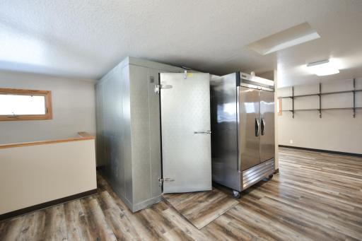 The walk-in cooler has been sold and the 2 door stainless cooler is available for purchase. IF both these items are removed it would open up a lot of space if you need it for your business. OR keep the 2 door stainless cooler and use it as needed.