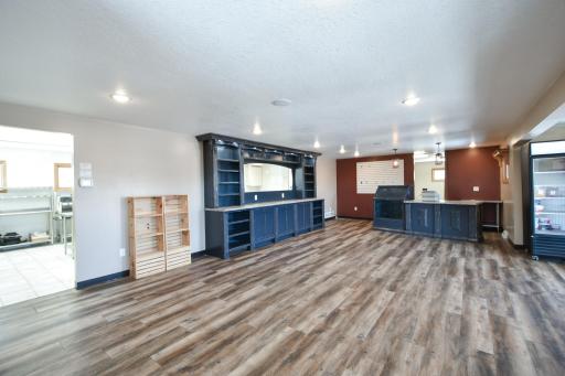 Expansive main entry show room, room for daycare, craft space so many options. Currently the shelving/cabinets that frame the kitchen window/ register table and display table are for sale seperately.