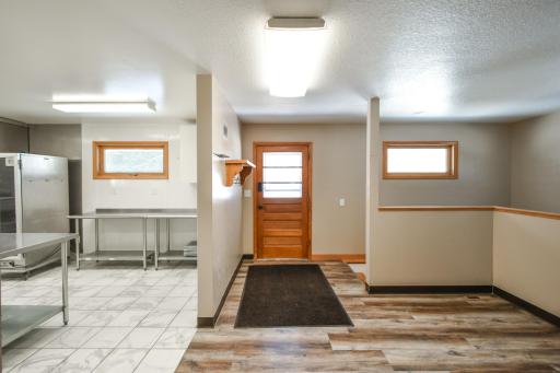 There is a parking area out the back door. There is a touch code door lock on the rear door. As you come in the back which does have a slight ramped access the lower level stairs are right inside the door.