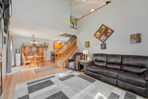 Open concept family room and dining area with high vaulted ceilings
