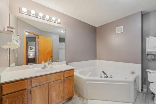 Spacious main bathroom with a jetted tub and walk-in shower.