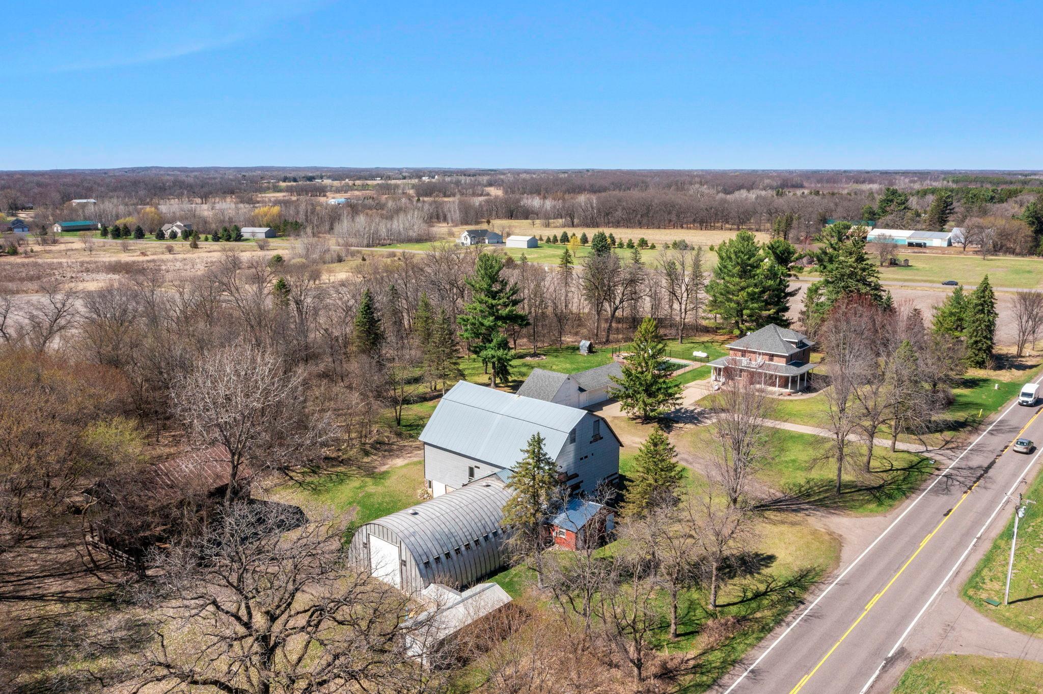 Welcome to 5 acres with PLENTY of space and storage areas to spread out in Nowthen, MN
