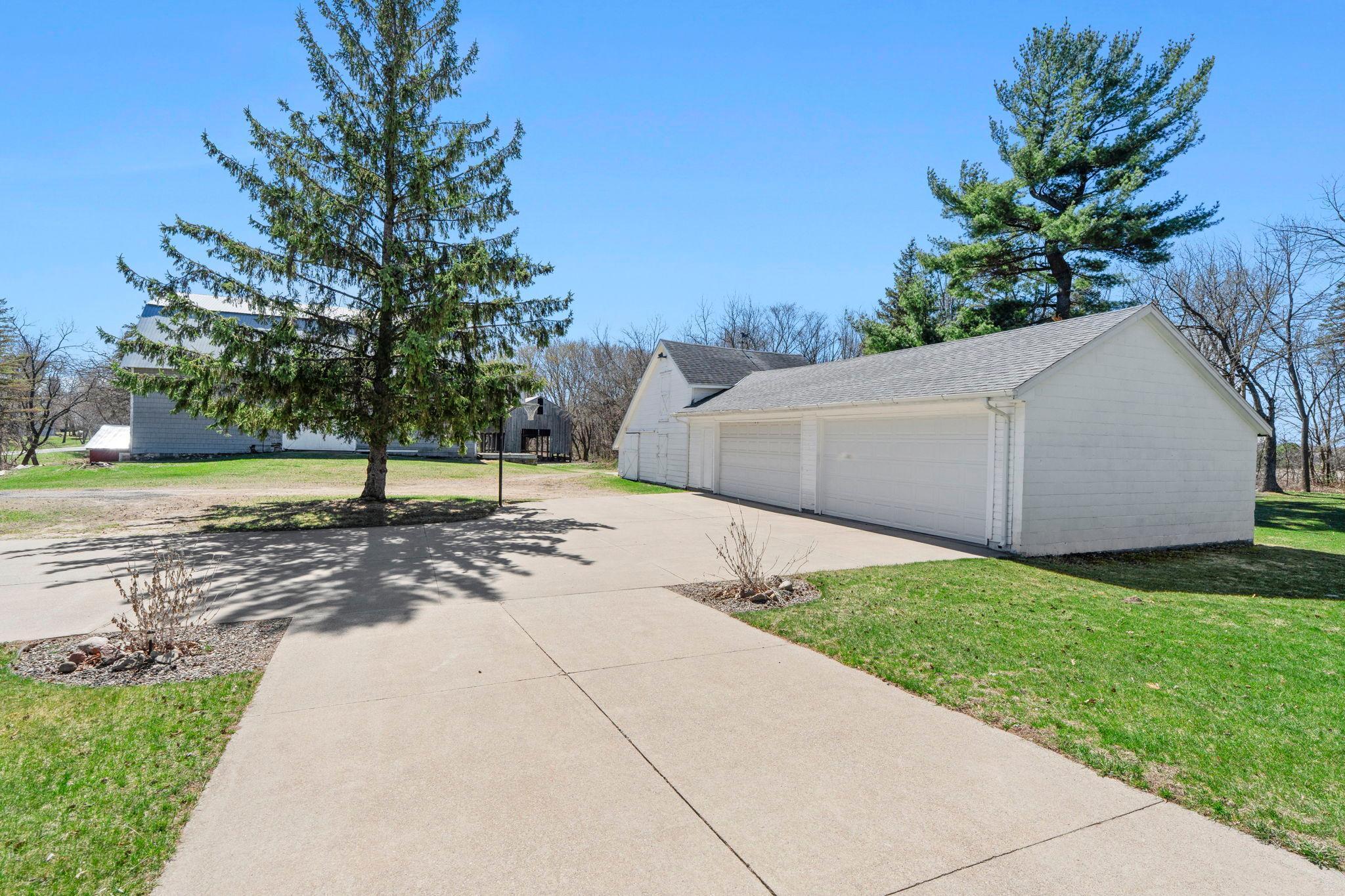 4 stall detached 1575 sf garage with plenty of additional storage on the side and a nice concrete driveway to play some basketball in!