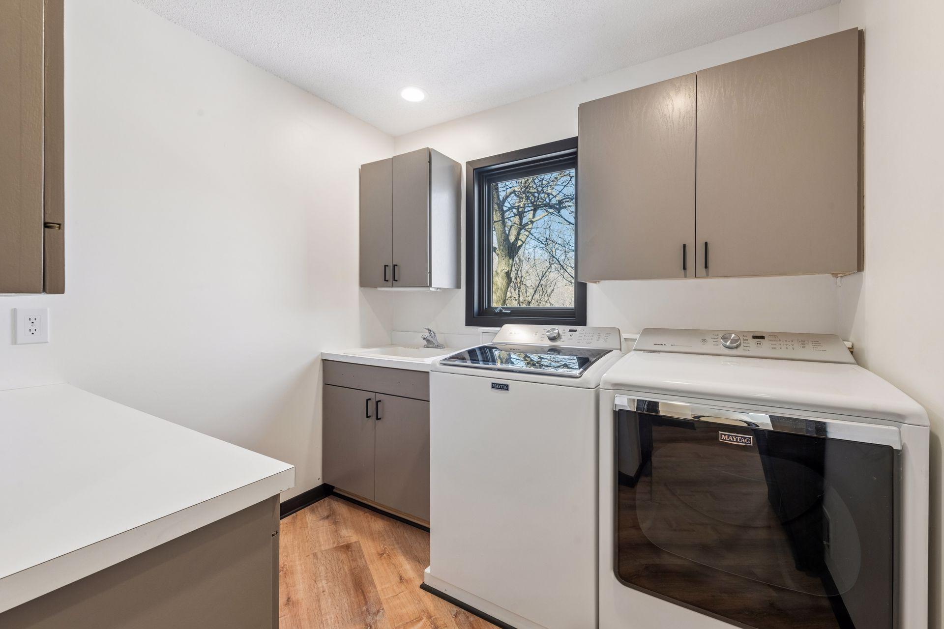 Convenient main floor laundry, with nice storage, sink and window to the backyard.