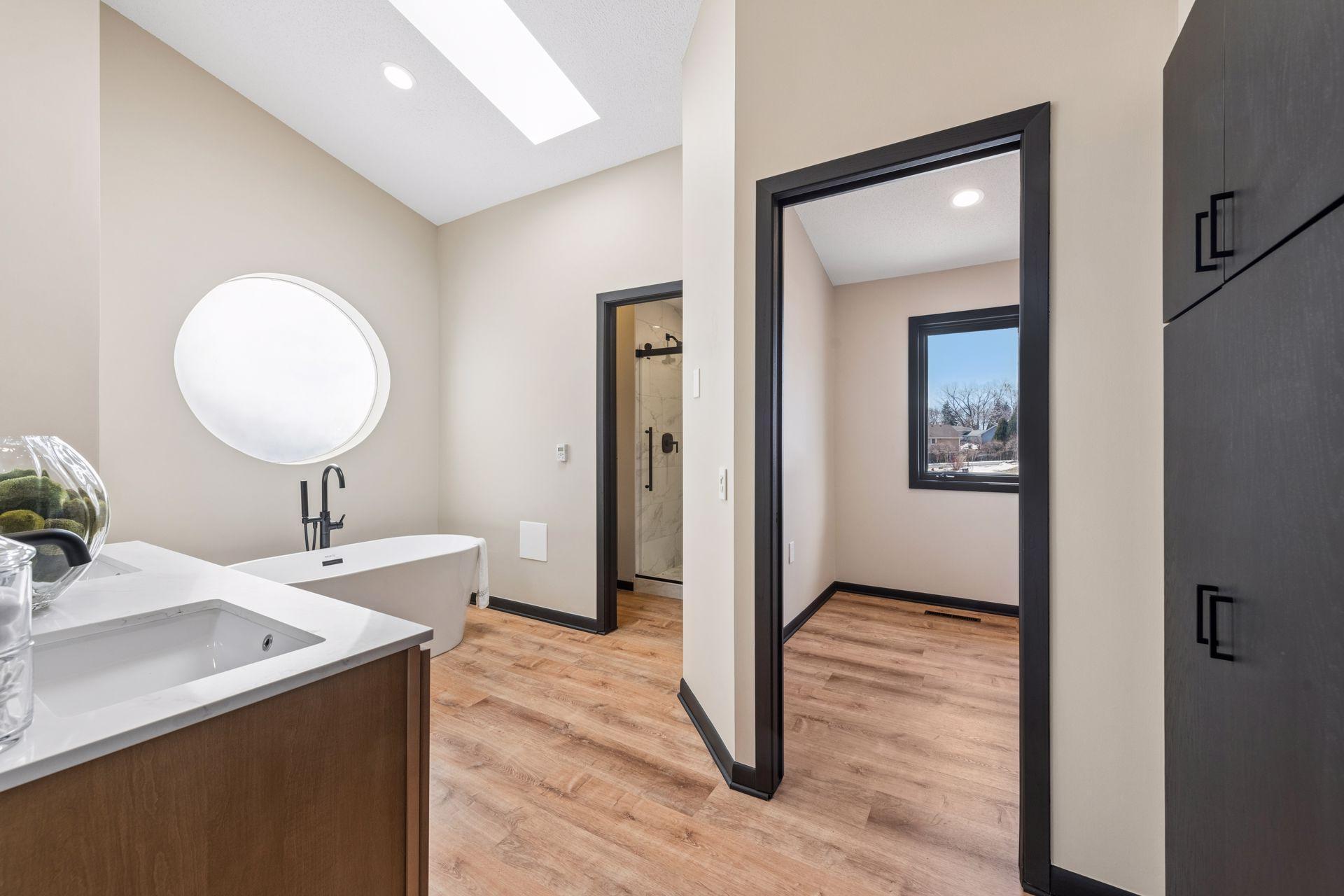 Large ensuite bath, with large walk-in closet and built-in storage cabinets.