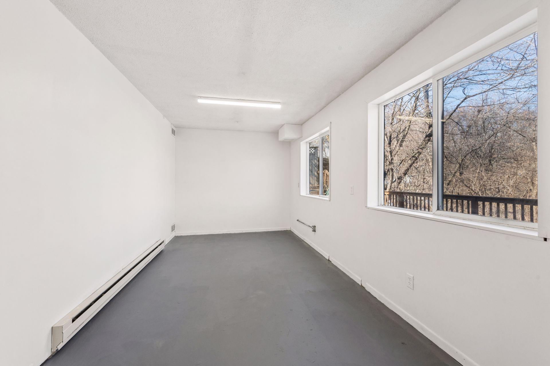 Third workshop/storage space, with bright windows overlooking the back deck.