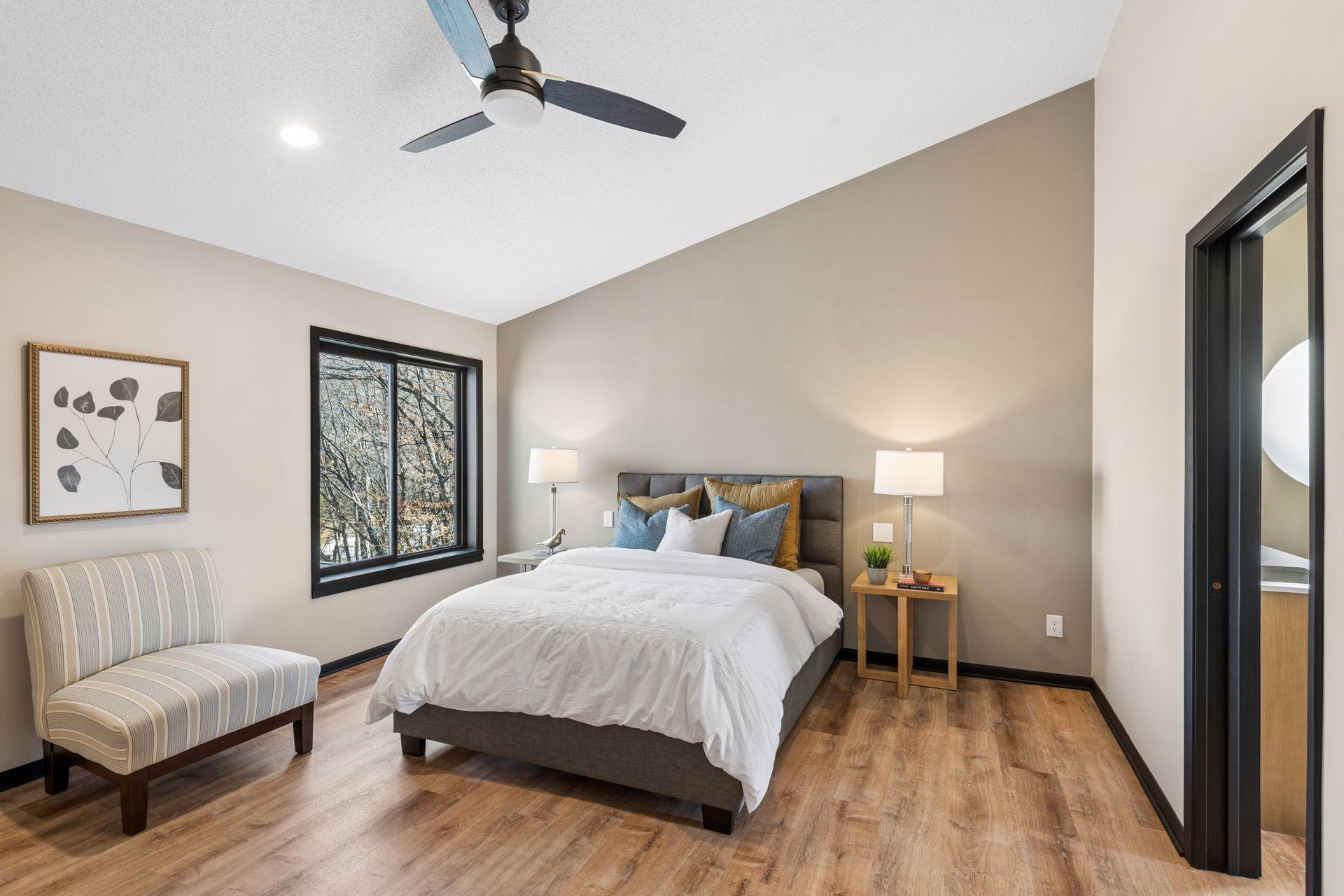 Large primary suite upstairs, with vaulted ceilings, overlooks the backyard.