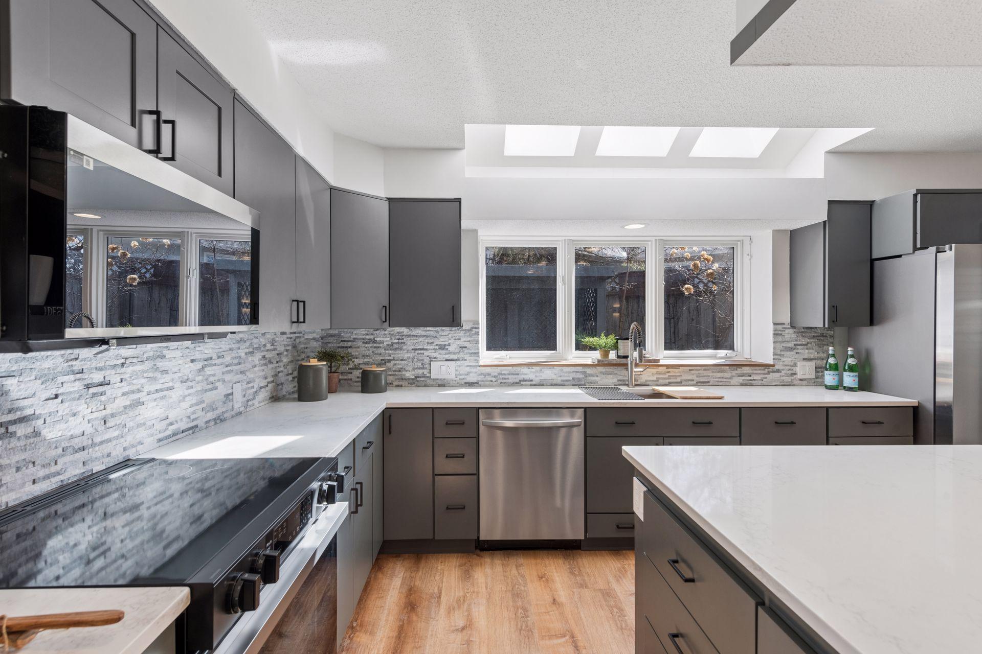 Large windows and a skylight create a bright and welcoming kitchen.
