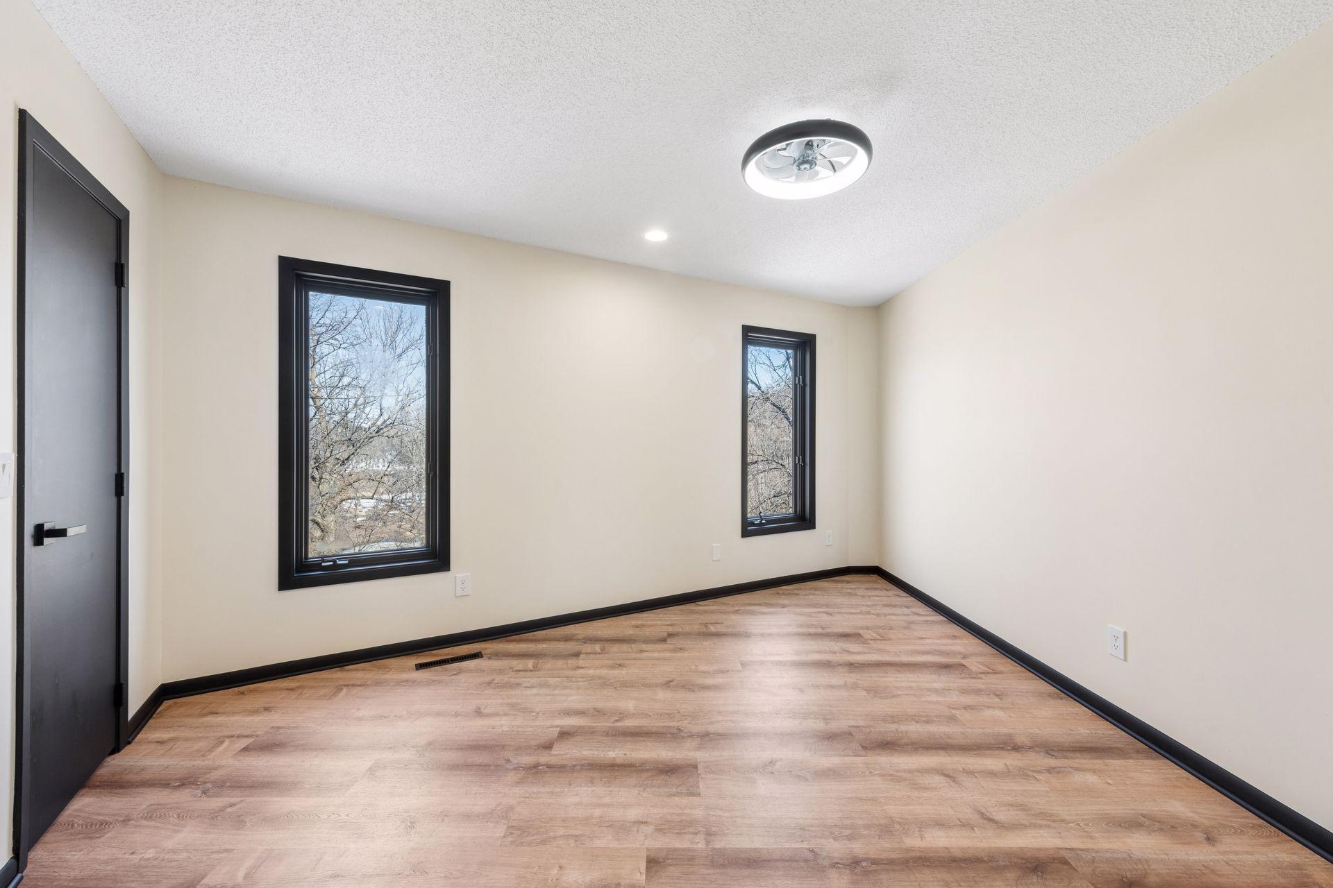 Third bedroom upstairs, also with new flooring and updated lighting.