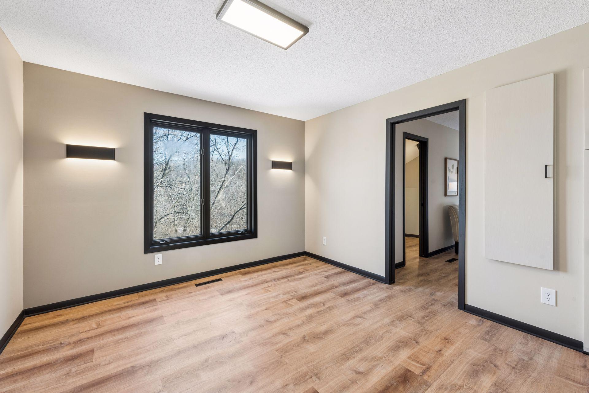 Second bedroom upstairs, with updated lighting and views of the backyard.