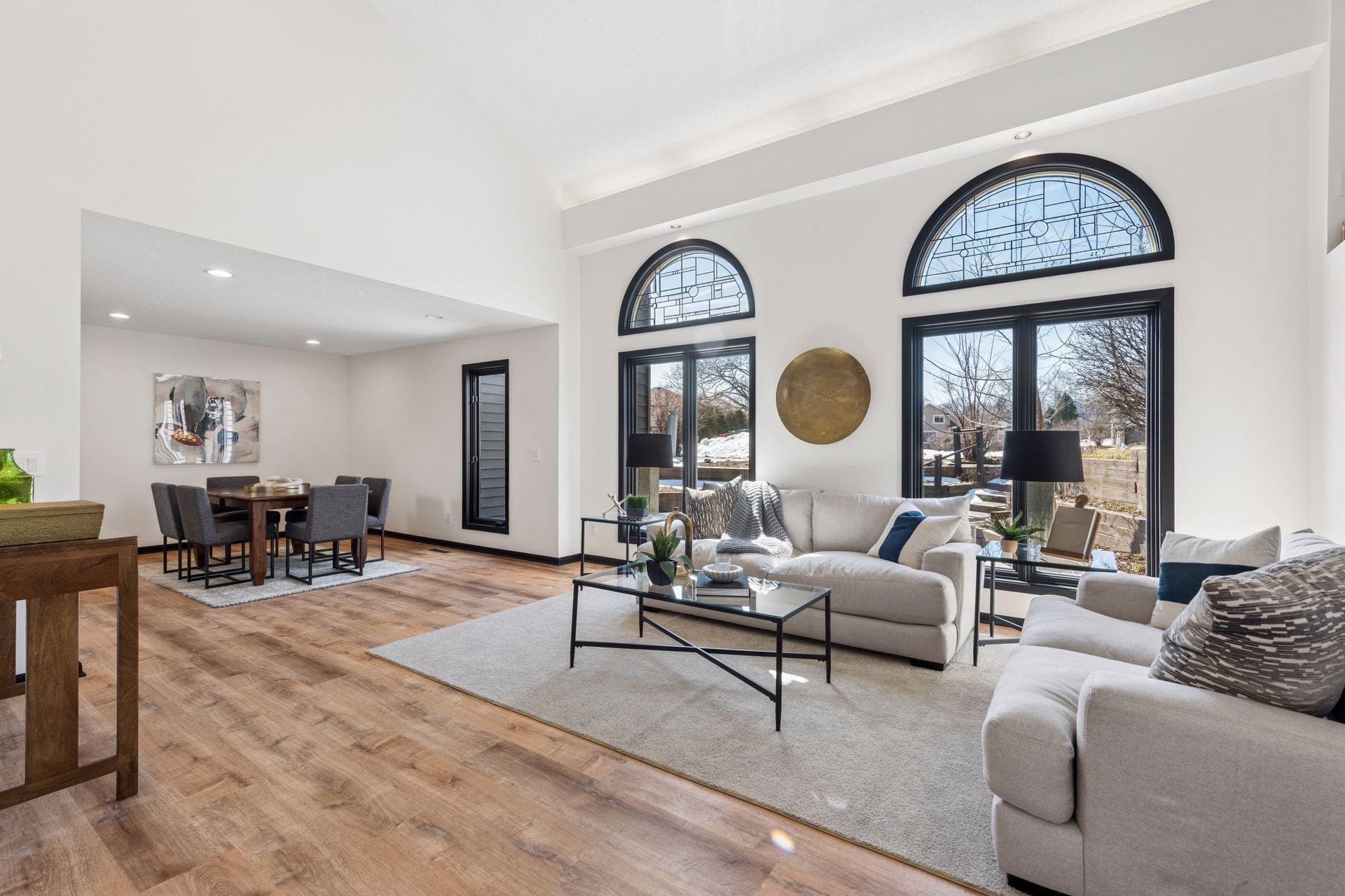 The main level welcomes you with a large open concept living room and formal dining room, with vaulted ceiling and large windows.