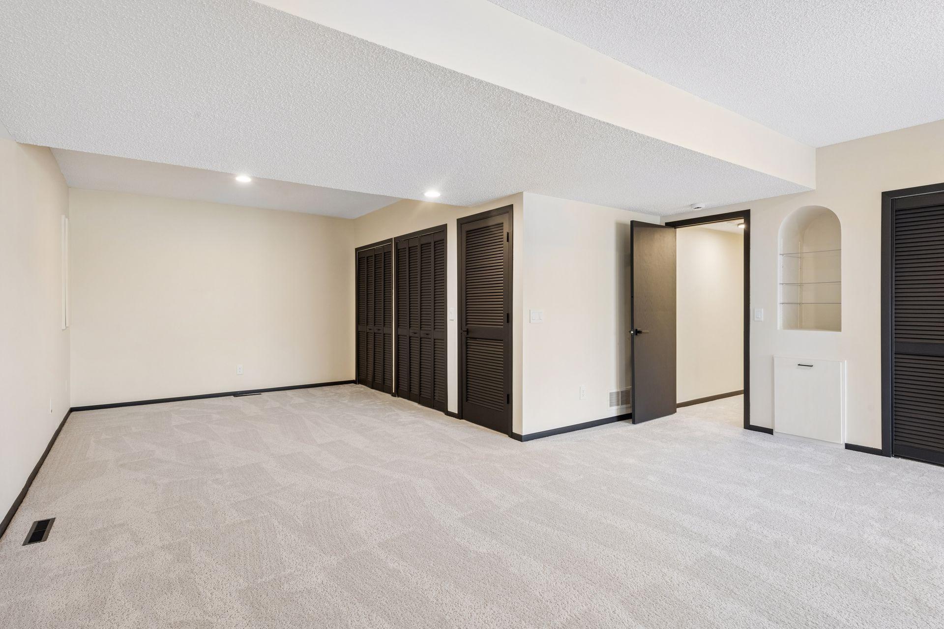 Large bedroom downstairs with multiple closets for storage, can also serve as a family room.