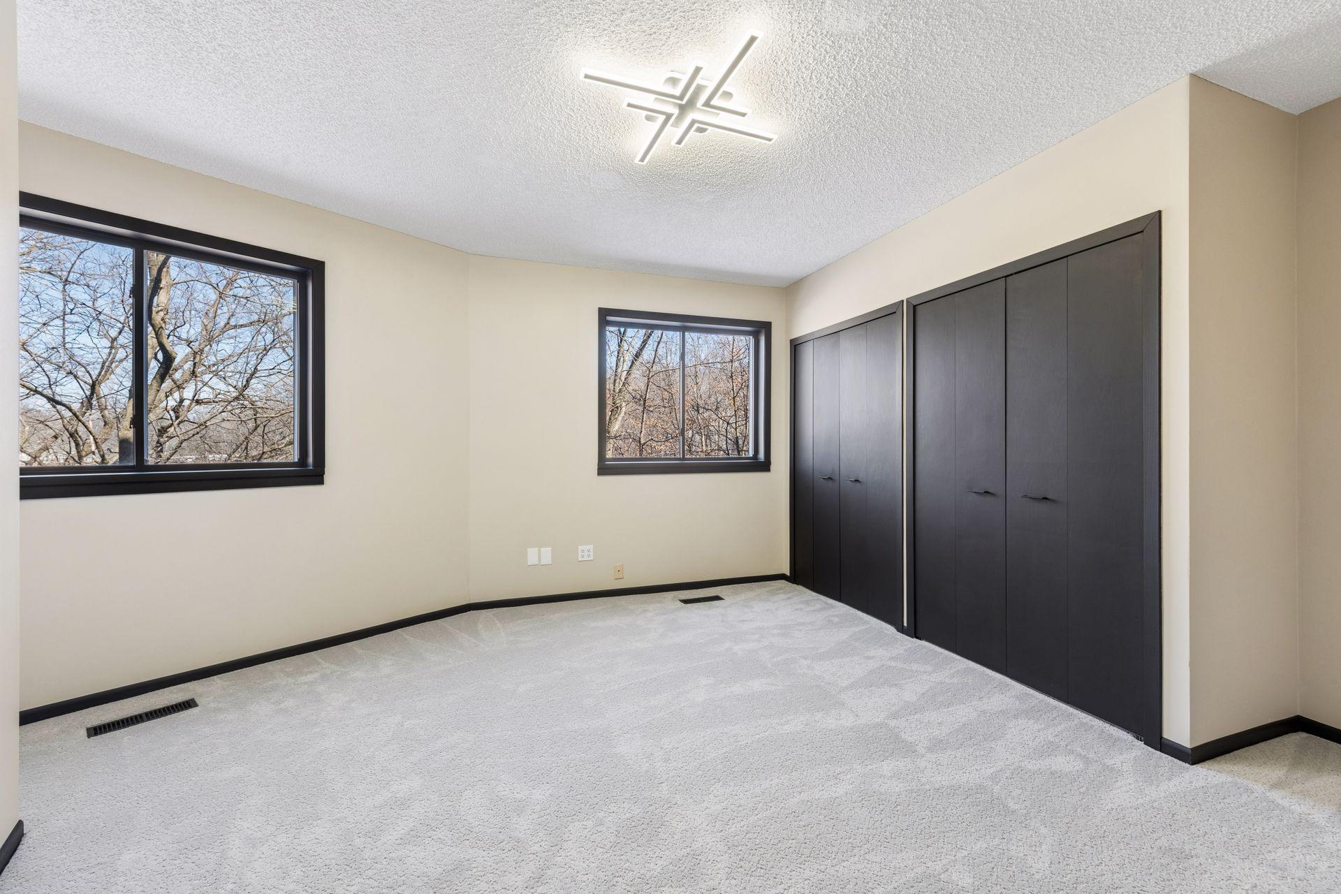 Second bedroom downstairs, with double-closets and views of the backyard.