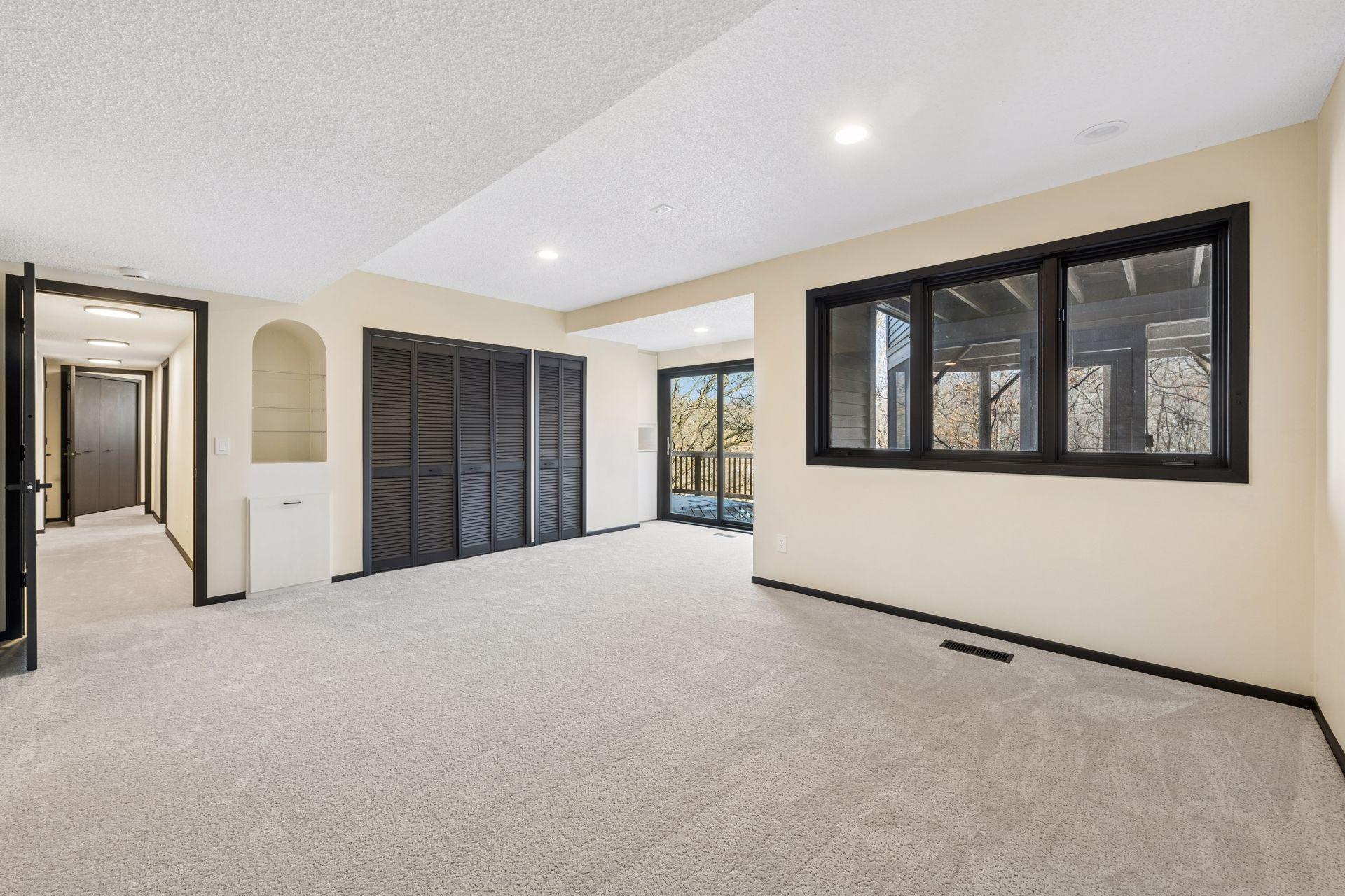 One of two basement bedrooms, this one with walkout access to the deck and brand new carpet throughout.